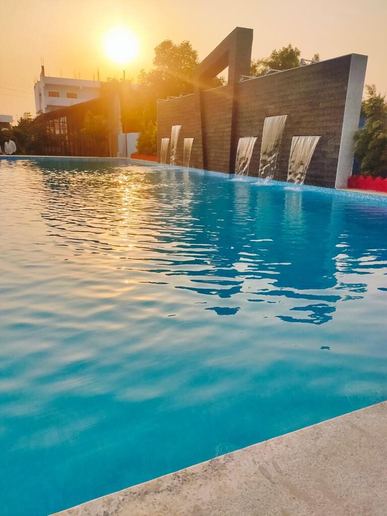 Infinity-edge swimming pool at sunset, built by Dream Pools